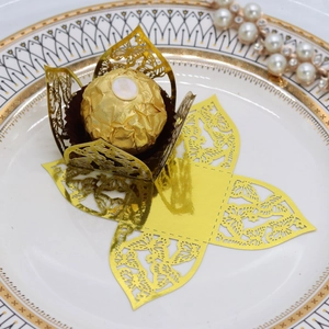 Macro shot of gold laser-cut butterfly chocolate wrappers for wedding favors