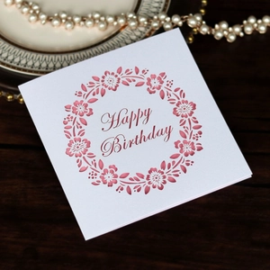 Elegant laser-cut square birthday card with pink floral wreath and Happy Birthday text