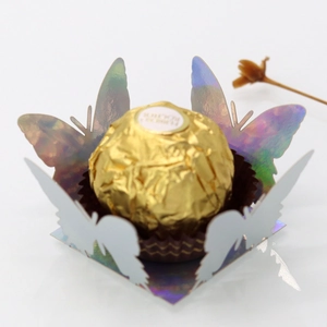 Macro detail of laser-cut gold mirror butterfly candy base for chocolate packaging