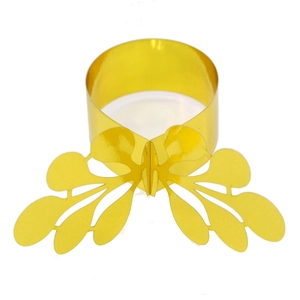 Close-up of golden hollow butterfly napkin ring with metallic luster for wedding decor