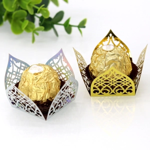 Detail of laser-cut gold and holographic silver chocolate wrappers with floral patterns