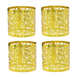 Detailed macro view of four gold mirror finish napkin rings with laser-cut floral patterns