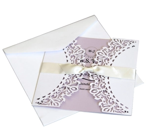Detailed laser cut lace invitation with purple RSVP card and cream satin bow accent