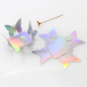 Macro detail of laser-cut iridescent butterfly wedding candy box with hollow design