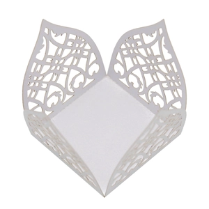 Macro detail of laser-cut lace floral patterns on premium pearlescent white paper gift box