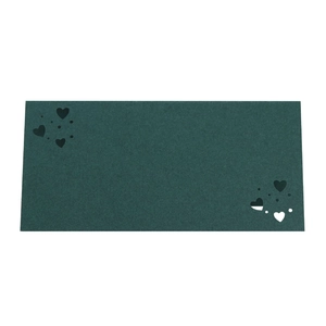 Detalle de tarjeta de mesa verde oscuro con diseño de corazones cortados por láser