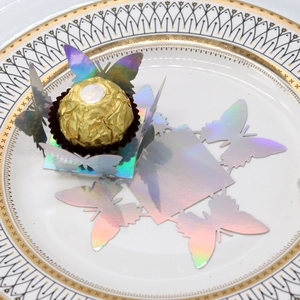 Iridescent laser-cut butterfly chocolate holder with shimmering finish for wedding favors