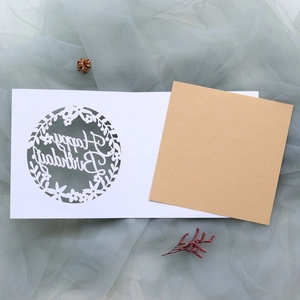 Detail of laser-cut Happy Birthday card with floral patterns and kraft paper insert