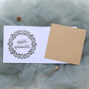 Detail of laser-cut floral wreath and Happy Birthday text on premium cardstock