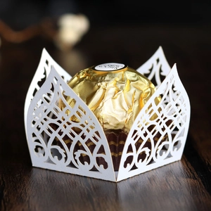 Detail of white laser-cut pearlescent paper wrapper with elegant lace patterns for chocolates