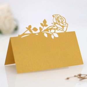 Macro shot of gold laser-cut rose place card made of premium pearlescent paper