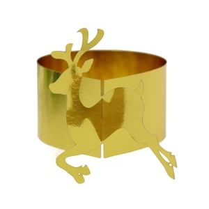 Close-up of golden reindeer paper napkin ring with reflective mirror finish for Christmas