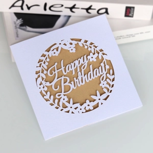 Detail of laser-cut Happy Birthday card with elegant floral hollow and kraft paper