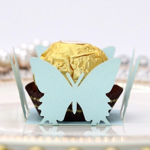 Close-up of laser-cut light blue butterfly chocolate holder with intricate lace hollow wings
