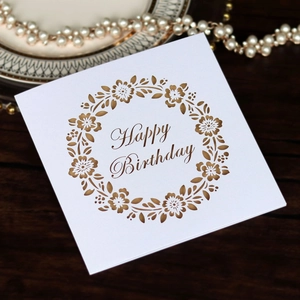 Detailed laser-cut hollow floral design on a premium white and gold Happy Birthday card