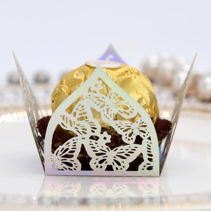 Macro detail of laser-cut butterfly chocolate box in pearlescent paper for wedding