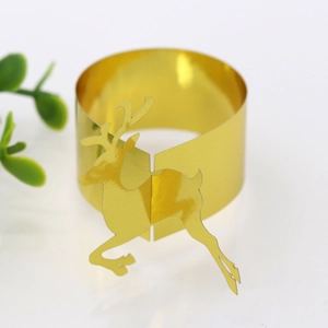 Close-up of golden reindeer paper napkin rings for festive Christmas table decoration