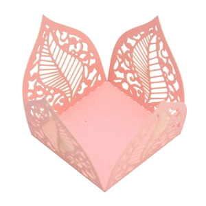 Macro view of pink pearlescent laser-cut hollow leaf design favor box for candies