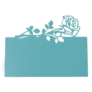 Laser-cut cyan wedding place card with detailed rose hollow pattern on white background