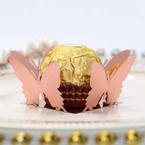 Detailed laser-cut rose gold butterfly chocolate holder for elegant party table decor
