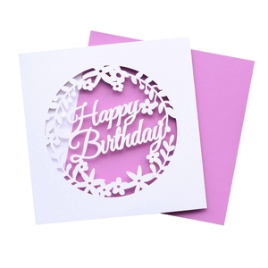 Macro shot of laser-cut Happy Birthday card with elegant purple floral contrast insert
