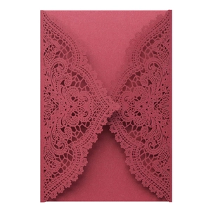 Detailed laser-cut intricate lace pattern on dark red pearlescent wedding invitation cover