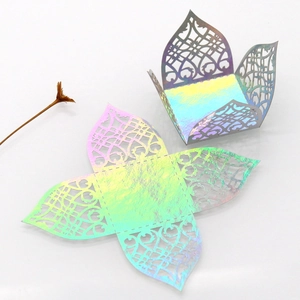 Detailed laser-cut heart pattern on shimmering iridescent gold candy gift boxes