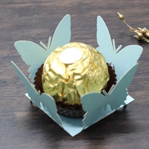 Macro shot of light blue laser-cut butterfly chocolate candy wrapper with lace texture