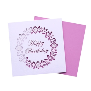 Detail of laser-cut floral wreath and Happy Birthday text on white and purple cards
