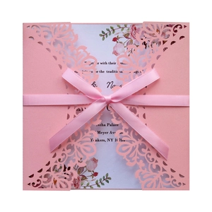 Pink laser-cut wedding invitation card with floral insert and elegant ribbon bow