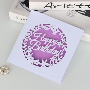 Detailed laser cut birthday card with white floral pattern and purple background