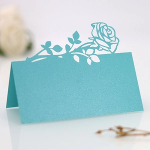 Laser-cut rose mint green name card with shimmering pearl finish and V-fold design