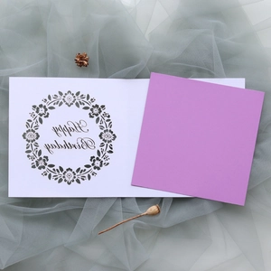 Detail view of laser-cut floral birthday card with purple insert and Happy Birthday script