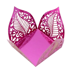 Detail showing laser-cut rose red metallic paper tray with intricate leaf vein patterns