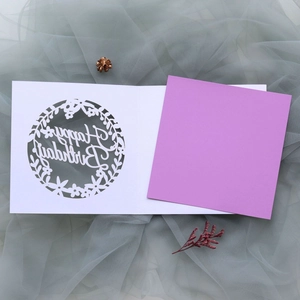 Laser-cut Happy Birthday card with purple insert and white floral wreath cutout