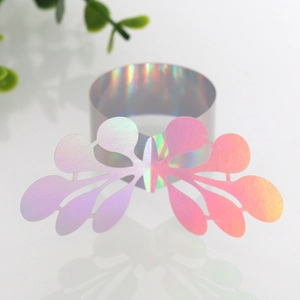 Macro detail of laser-cut butterfly napkin ring with iridescent holographic finish