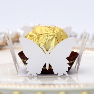 Detailed close-up of a white hollow butterfly paper candy box with gold foil chocolate