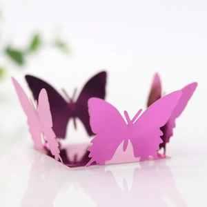 Macro detail of laser-cut butterfly decorations for weddings with metallic finish