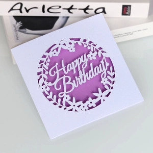 Laser cut Happy Birthday greeting card with floral design and purple lining on white paper