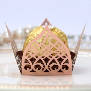 Detail of rose gold laser-cut heart pattern chocolate wrapper for weddings
