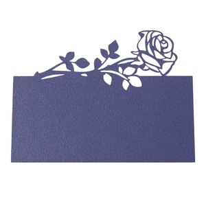Detail of laser-cut dark blue rose place card featuring intricate floral hollow pattern