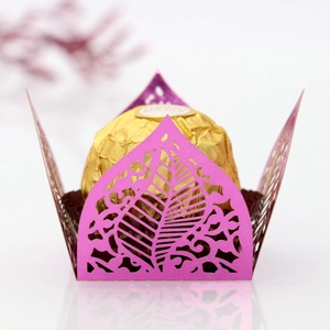 Detail of pink laser-cut leaf pattern candy holder with a chocolate display
