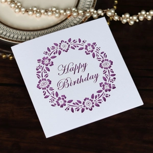 Elegant laser-cut Happy Birthday card with purple floral hollow patterns on white paper