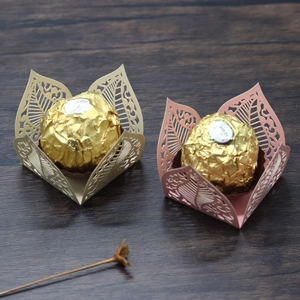 Laser-cut floral chocolate wrappers in gold and pink with elegant hollow leaf patterns