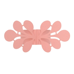 Macro detail of laser-cut soft pink paper napkin ring with intricate floral lace pattern