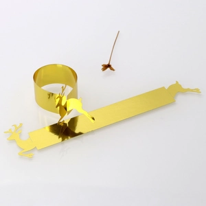 Flat lay of gold mirror reindeer napkin rings in both flat and folded circular shapes
