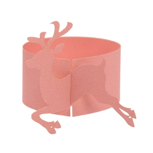 Detail view of a laser-cut pink paper reindeer napkin ring for Christmas table decor