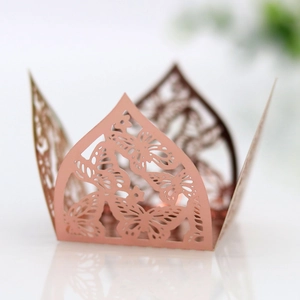 Detail of rose gold laser-cut butterfly wrapper with intricate pearlescent hollow pattern