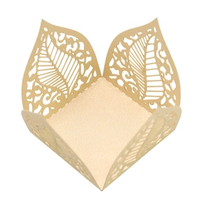 Macro detail of laser-cut hollow leaf patterns on champagne gold pearlescent paper box