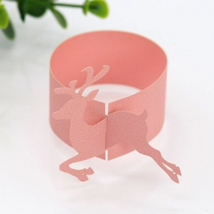 Detailed laser-cut elk design on pink pearlescent paper napkin ring for Christmas decor